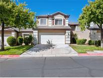 Two-story home with attached garage and manicured lawn at 425 Blush Creek Pl, Las Vegas, NV 89144