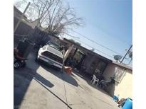 Home's backyard with a gravel area and various items at 2315 Perliter Ave, North Las Vegas, NV 89030