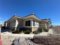 Tan stucco house with a two-car garage and desert landscaping at 3378 Pheasant Canyon Way # 1003, Laughlin, NV 89029