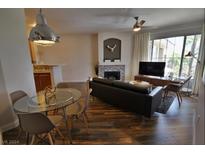 Open living room with hardwood floors and fireplace at 7173 S Durango Dr # 310, Las Vegas, NV 89113