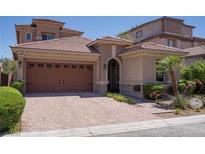 Two-story home with a large, attached garage and manicured landscaping at 7851 Granite Walk Ave, Las Vegas, NV 89178