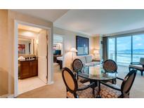 Living room with dining area and access to a bathroom at 145 E Harmon Ave # 1908, Las Vegas, NV 89109