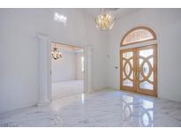 Elegant entryway with marble floors and chandelier at 2951 Aruba Ct, Las Vegas, NV 89121