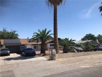 Ranch-style home with solar panels and palm trees at , Las Vegas, NV 89108