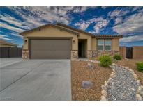 Single story home with a two-car garage and desert landscaping at 3525 Umatilla Ave, Pahrump, NV 89061