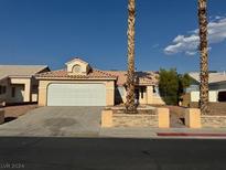 Single-story house with a two-car garage and desert landscaping at 4848 Califa Dr, Las Vegas, NV 89122