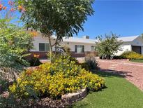 Landscaped front yard with walkway and flowers at 4923 E Cleveland Ave, Las Vegas, NV 89104