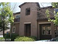 Two-story stucco home with balcony and mature landscaping at 1837 Ardilea St, Las Vegas, NV 89135