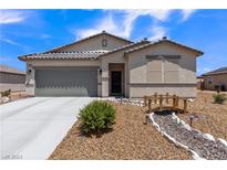 One-story house with a gray garage door and landscaped yard at 3558 E Malheur Ave, Pahrump, NV 89061