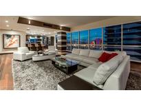 Luxury living room with hardwood floors, city views, and modern furniture at 4525 Dean Martin Dr # 2200, Las Vegas, NV 89103