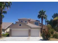 Two-story house with three-car garage at 4774 Willow Glen Dr, Las Vegas, NV 89147