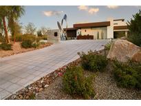 Modern home exterior with stone driveway and landscaping at 11587 Stardust Dr, Las Vegas, NV 89135
