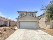 Two-story house with attached garage and desert landscaping at 9509 Swiss Stone Ct, Las Vegas, NV 89123