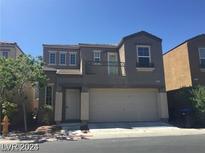 Two-story house with attached garage and balcony at 9229 Millikan Ave, Las Vegas, NV 89148