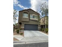 Two story home with a two-car garage and neutral colors at 8925 Hull Bay Ave, Las Vegas, NV 89149