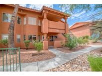 Two-story building with terracotta-colored exterior and walkway at 845 Mesquite Springs Dr # 102, Mesquite, NV 89027
