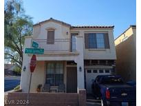 Two story house with balcony, attached garage, and driveway at 9794 Villa Lorena Ave, Las Vegas, NV 89147