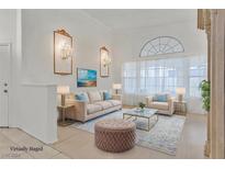 Virtually staged living room featuring a comfortable sofa, and large windows at 233 Comanche Ct, Henderson, NV 89074