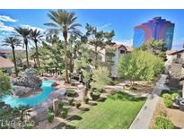 Community pool with a waterfall feature and landscaping at 4200 S Valley View Blvd # 3051, Las Vegas, NV 89103