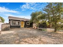 House exterior with yellow door and trampoline at 3104 Dillon Ave, North Las Vegas, NV 89030