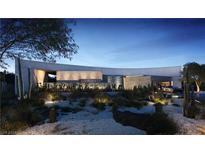 Modern desert contemporary home with stone and stucco exterior at dusk at 10 Chisel Crest Ct, Henderson, NV 89012