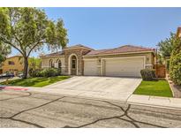 House exterior featuring a three-car garage and well-maintained landscaping at 1505 Barrington Oaks St, North Las Vegas, NV 89084
