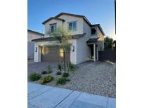 Two-story house with attached garage and landscaping at , North Las Vegas, NV 89086