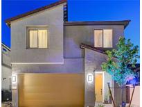 Modern two-story home with a yellow garage door and stylish exterior at 10407 Restless River St, Las Vegas, NV 89141