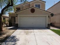 Two-story house with attached garage and landscaping at 3254 Gold Run St, North Las Vegas, NV 89032