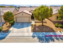 Single-story house with two-car garage and desert landscaping at 7824 Homing Pigeon St, North Las Vegas, NV 89084