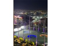 Night view overlooking the city and a lighted driving range at 135 E Harmon Ave # 2004, Las Vegas, NV 89109