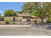 Charming home featuring mature trees, desert landscaping, and a welcoming front entrance at 5102 Village Dr # 49, Las Vegas, NV 89142