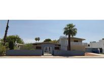 Mid-century modern home with a gated entrance and palm trees at 3418 Oneida Way, Las Vegas, NV 89169