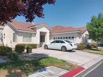 House exterior with a two car garage and landscaping at 1625 Pacific Tide Pl, Las Vegas, NV 89144