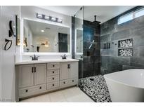 Modern bathroom with double vanity, soaking tub, and walk-in shower at 6630 Evander St, North Las Vegas, NV 89086