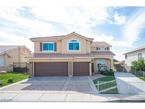 Two-story house with brown double doors and a two-car garage at 6611 Caddington Ave, Las Vegas, NV 89110