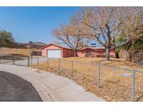 Ranch style home with a single car garage and mature trees at 604 Jade Cir, Henderson, NV 89002