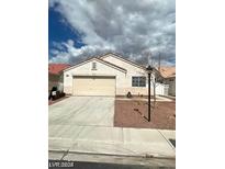 Single-story house with a two-car garage and landscaped yard at 336 River Glider Ave, North Las Vegas, NV 89084