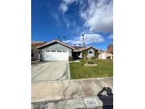 Single-story home with a two-car garage and landscaped lawn at 2802 Camelback Ln, Henderson, NV 89074