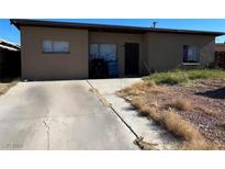 Ranch style home with a long driveway and mature landscaping at 424 Stanford St, Las Vegas, NV 89107