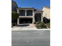 Two-story home with attached garage and landscaped yard at 6026 Montana Peak Ave, Las Vegas, NV 89139