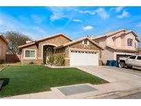 Single-story home with stone facade, white garage door, and artificial turf at 2903 Galena Peak Ln, Las Vegas, NV 89156