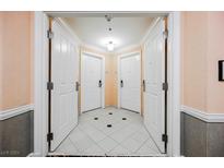 Interior condo entryway with two doors and tile floor at 125 E Harmon Ave # 2401&2403, Las Vegas, NV 89109
