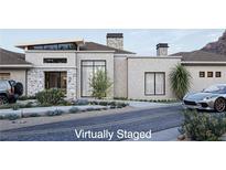 Virtually staged modern home exterior with stone accents and a sleek design at 16 Shadow Canyon Ct, Las Vegas, NV 89141