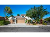 Two-story house with attached garage and landscaping at 1335 Temporale Dr, Henderson, NV 89052