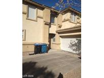 Tan two-story house with a white garage door at 1432 Evening Song Ave, Henderson, NV 89012