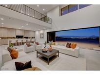 Open living room with high ceilings, modern furniture, and stunning views at 1458 Dragon Stone Pl, Henderson, NV 89012