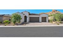 Two-story home with a two-car garage and landscaped yard at 34 Barrio Alto Ct, Henderson, NV 89011