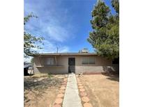 Single story home with a walkway leading to the entrance at 2100 Dogwood Ave, North Las Vegas, NV 89030