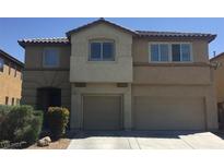 Two-story house with a three-car garage and landscaped front yard at 3608 Tundra Swan St, Las Vegas, NV 89122